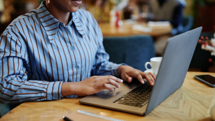 Hands on a laptop keyboard.